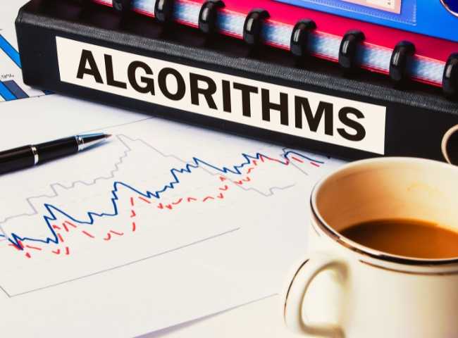Binder labeled 'Algorithms' next to charts and a coffee cup.